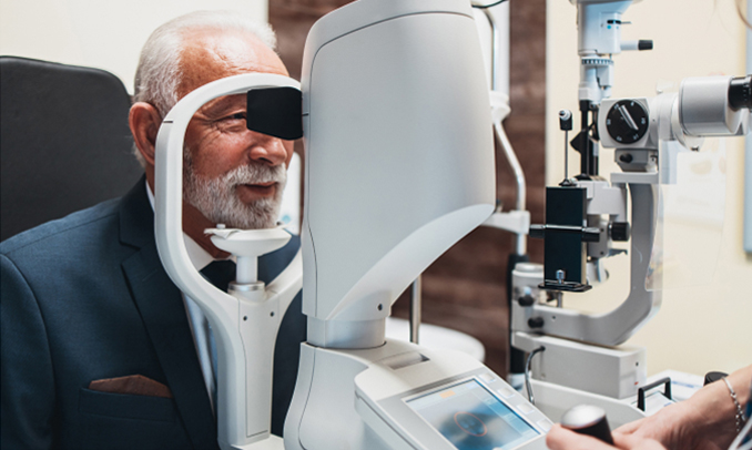 A senior man undergoing an eye examination using advanced optical equipment at Bristol Family Eye Care clinic.